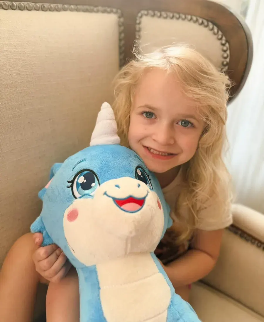 A smiling girl hugging Pearl