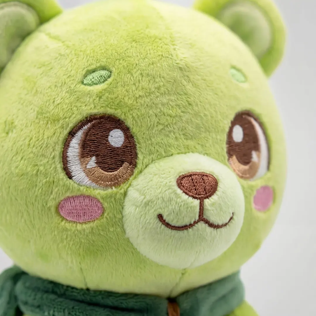 A close-up of Sprout’s embroidered face